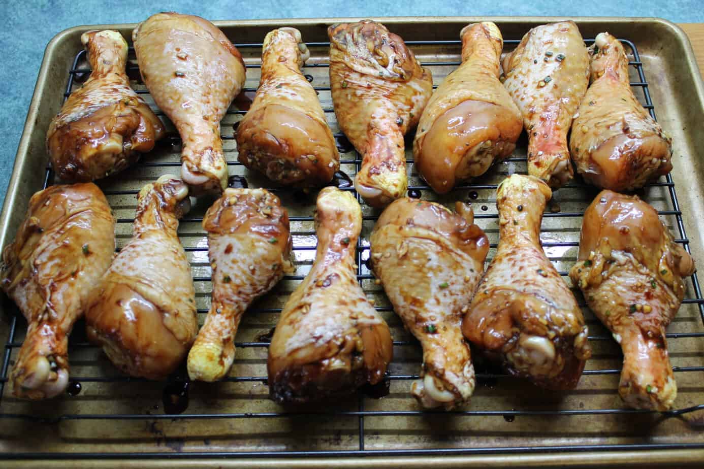 Balsamic and maple glazed, oven baked chicken drumsticks on a wire roasting rack