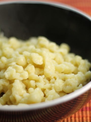 Close up of German spätzle noodles served in a black bowl