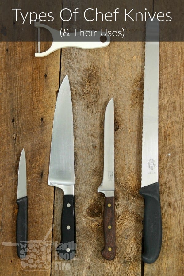 a collection of chefs knives on a wood board table