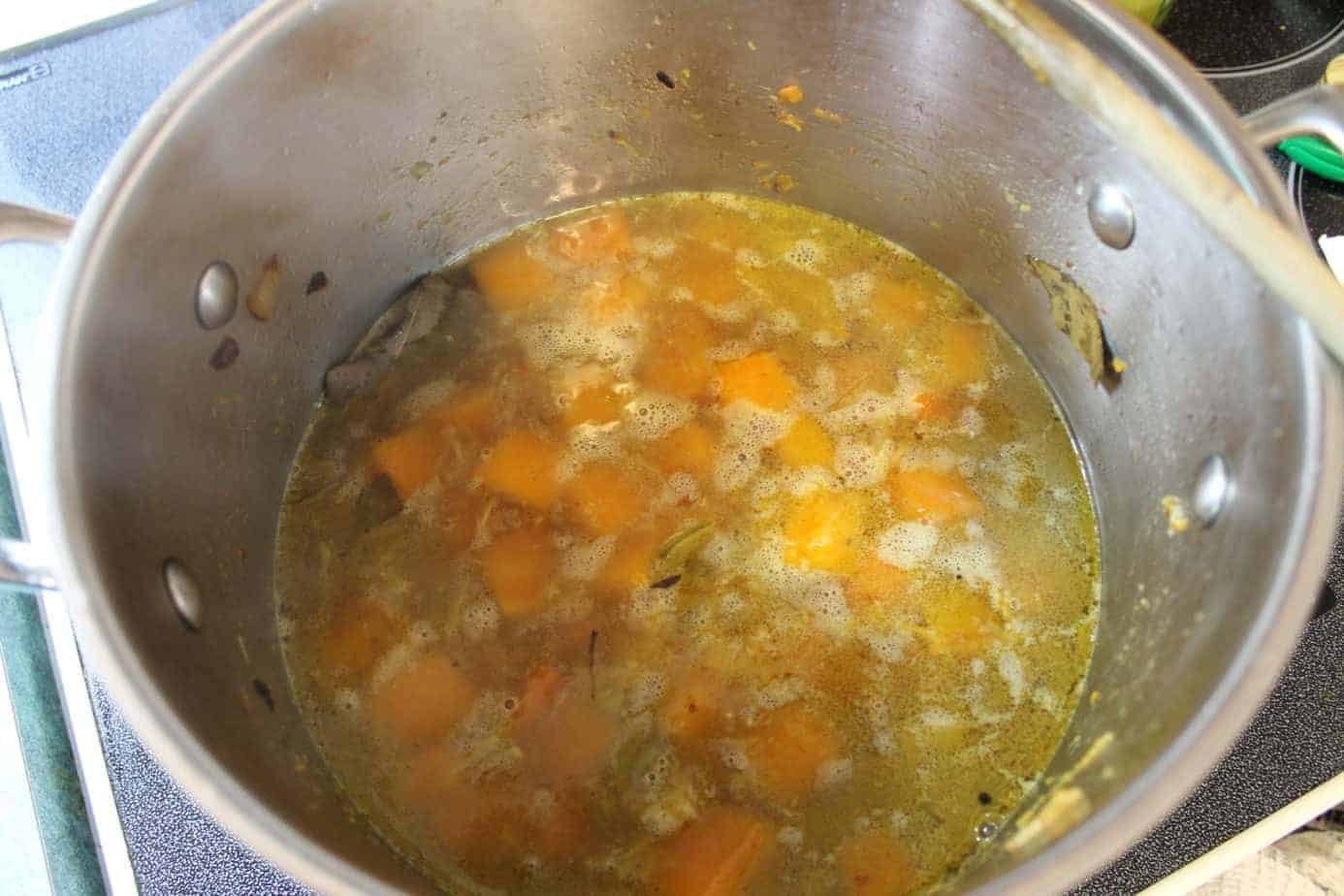 butternut squash soup simmering on a stove
