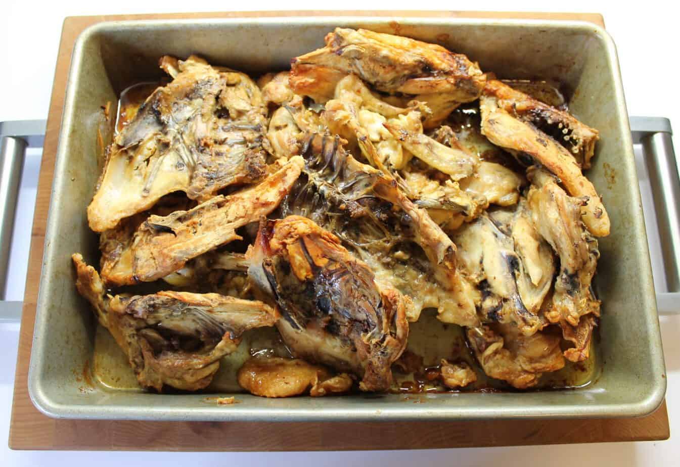 Roasted chicken bones in a deep roasting pan