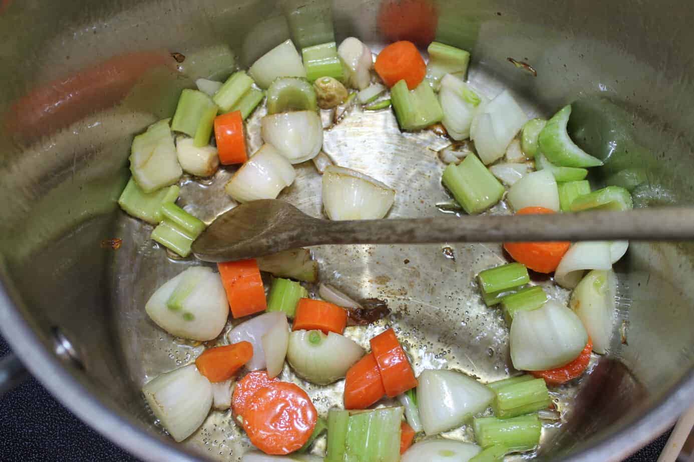 sauteing carrots onions and celery in a pot