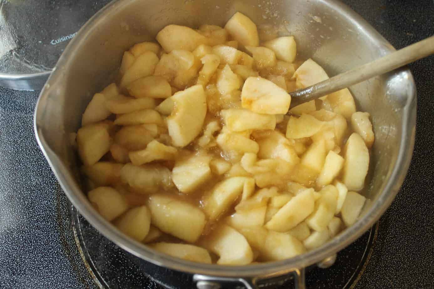 Apples cooking in a pot to make apple pie filling