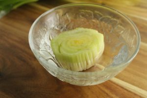 a celery root core placed in a small dish of water