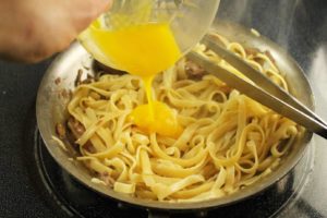 Adding egg to the pasta