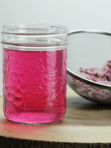Home made chive blossom vinegar is a great way to us up excess chive flowers from your garden. Simple to make this homemade condiment, produces a stunning color! Great for use in marinades, dressings, and sauces!