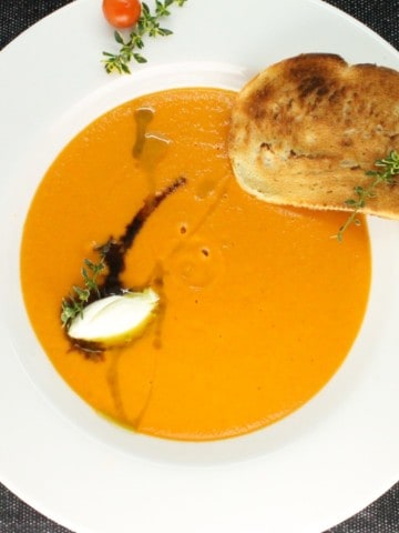 This Oven Roasted Tomato Soup with a hint of lemon thyme takes the classic recipe to a new level. Sweet and packed full of tomato flavor, this makes a great appetizer or re-heated for lunch,