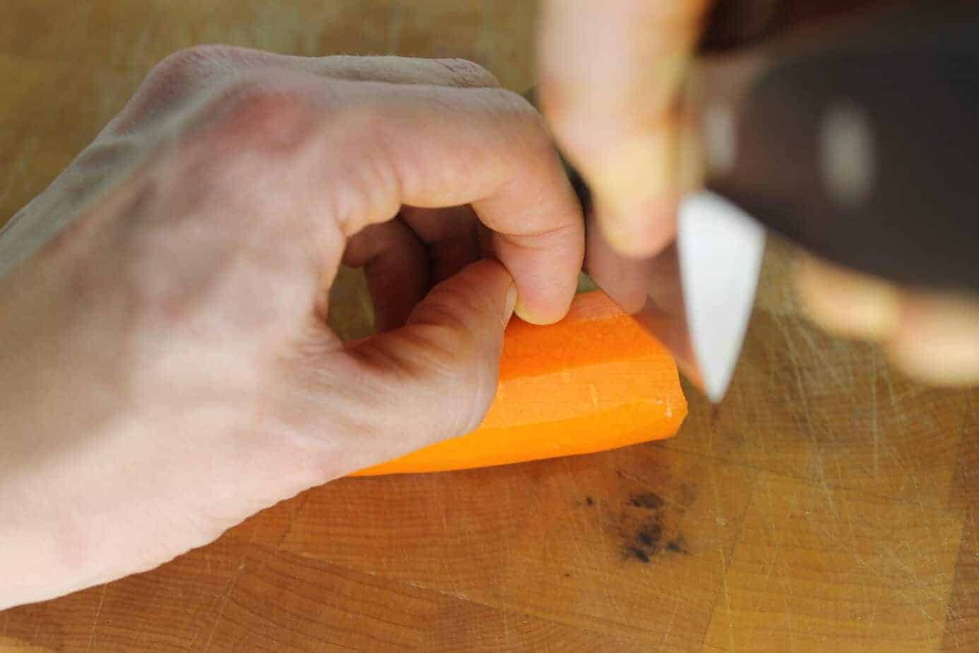 Curling your fingers in like this will ensure that you never cut yourself, the blade slides along your knuckle but the cutting edge is never close to your finger tips.