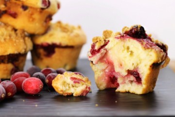 Bake these delicious bakery-style cranberry muffins at home! Fluffy, moist and full of fresh fruit, these muffins are a hit in any family!