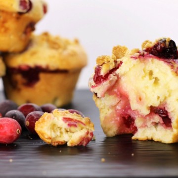 Bake these delicious bakery-style cranberry muffins at home! Fluffy, moist and full of fresh fruit, these muffins are a hit in any family!