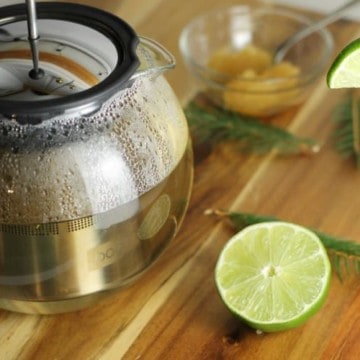 Let spruce tea steep for 10 to 15 minutes before adding the honey and lime for a delicious and healthy beverage.