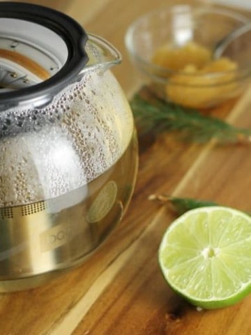 Let spruce tea steep for 10 to 15 minutes before adding the honey and lime for a delicious and healthy beverage.