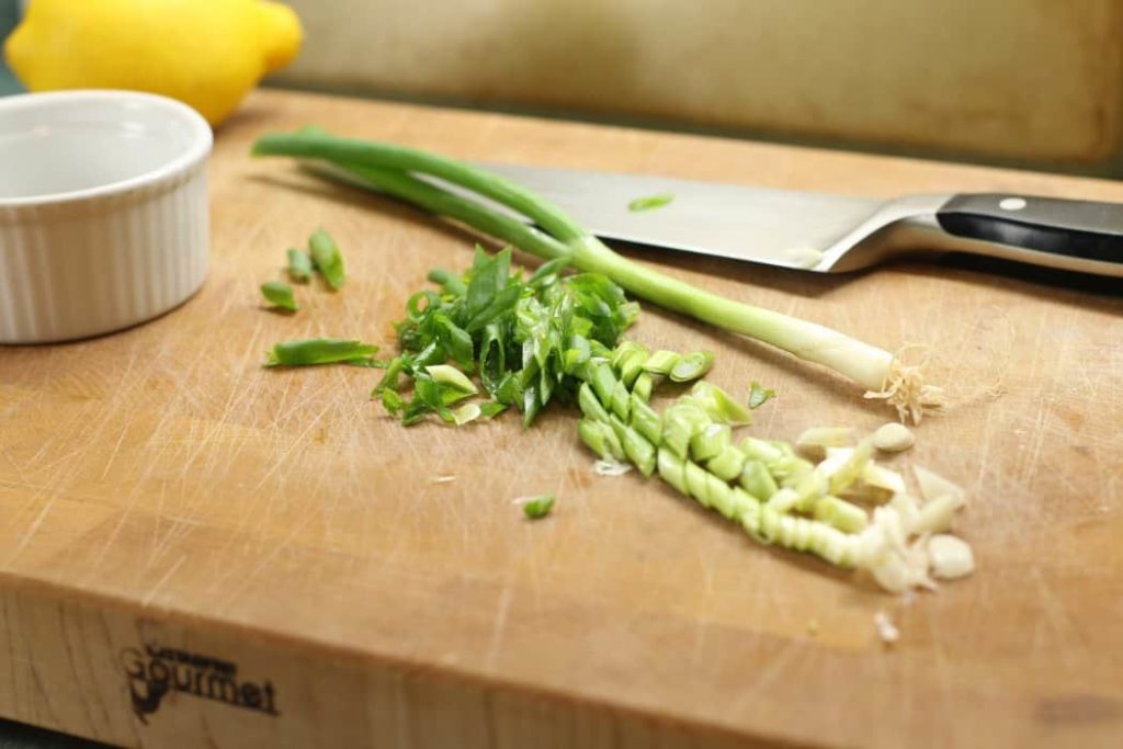 Baled haddock mise en place - green onions, parsley, and lemon