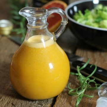 a glass bottle containing fresh grapefruit vinaigrette.