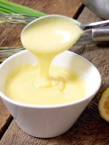 easy homemade hollandaise sauce in a white dish