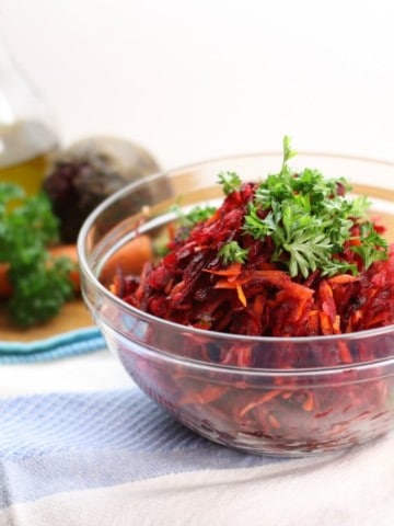 Using just a simple box grater, this healthy shredded beet salad with, carrots, apples, and walnuts is a great side to any meal. Clean eating and Paleo friendly