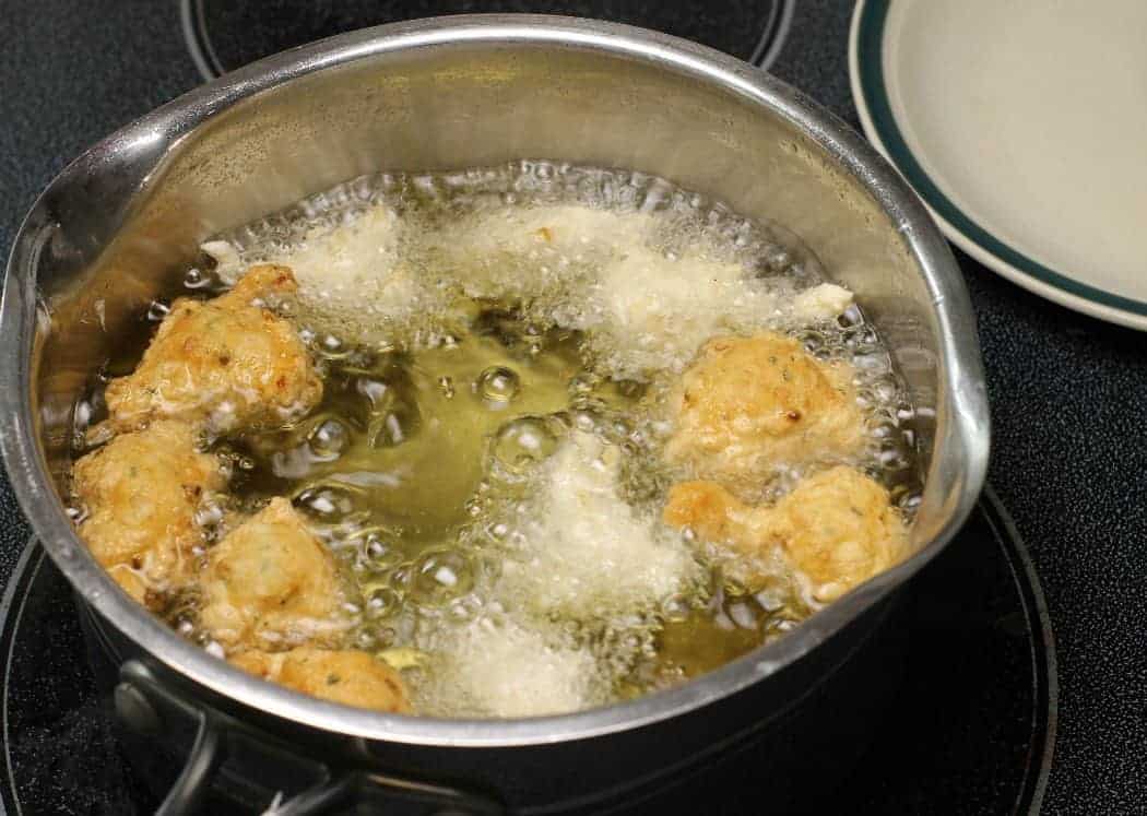 Fry the Bajan Fish Cakes in oil, either in a pot over medium heat or a portable deep fryer!