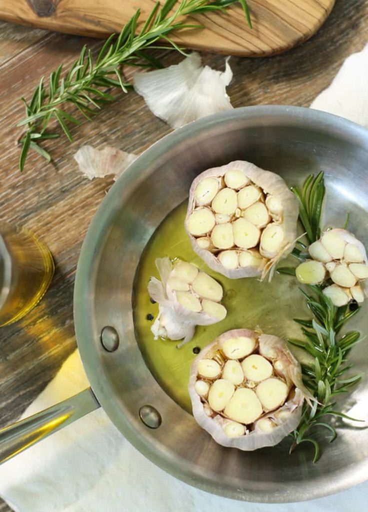 raw garlic in a pan with oil before roasting