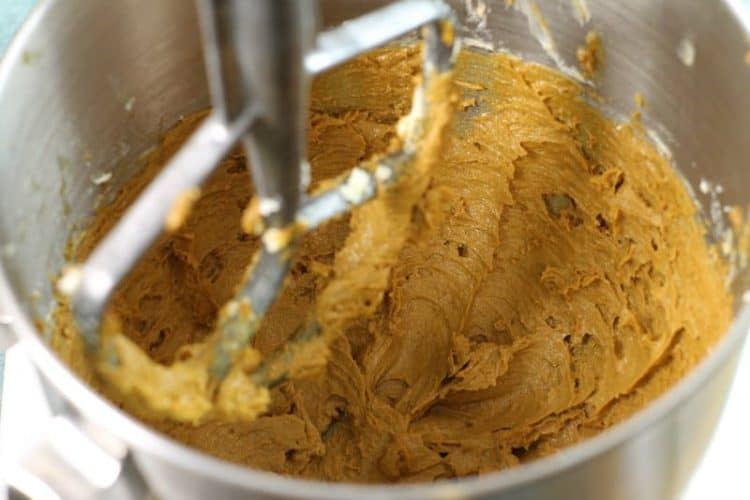 pumpkin muffin batter being mixed in a kitchen aid mixer bowl
