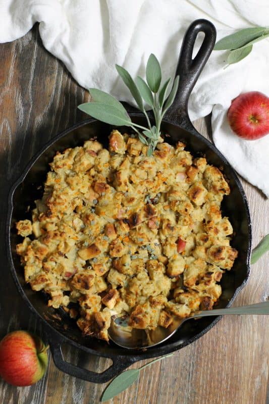 Easy to make, moist, and full of flavor, this apple and sage stuffing cooked in a cast iron skillet will become your new favorite dressing recipe! #skillet #stuffing #dressing #thanksgiving #apple