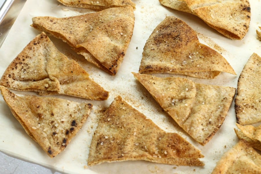 Sprinkle th homemade pita chips with your favorite spice mix, and then bake!