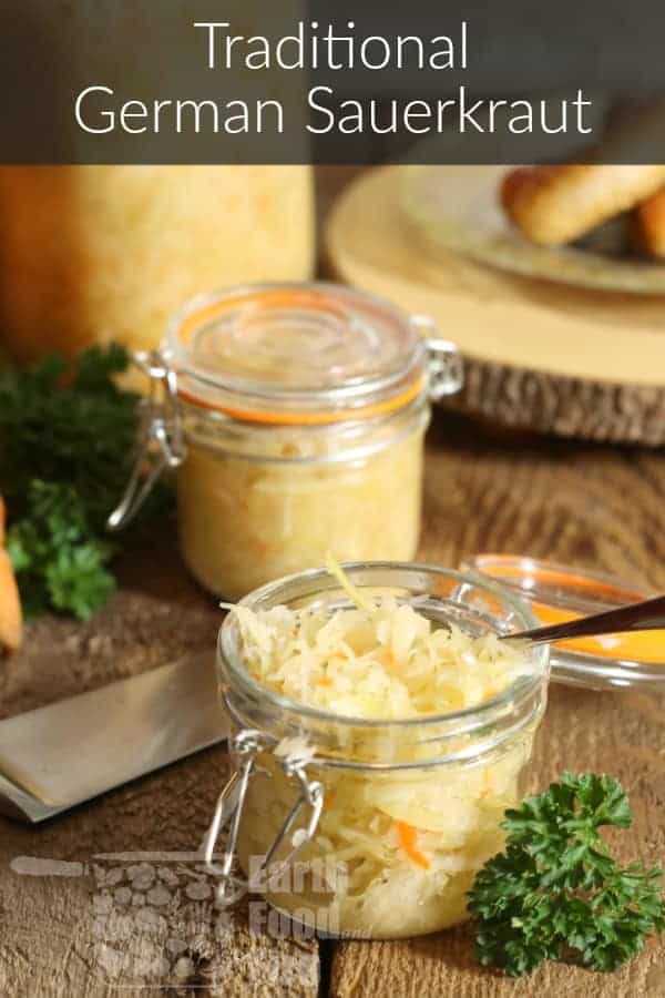close up of a small glass jar of german sauerkraut on a barn board table