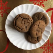 brown gingersnap cookies on a white scalloped plate