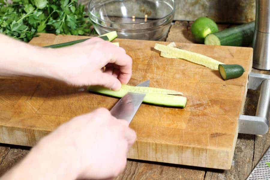 de-seeding a cucumber cut into quarters.