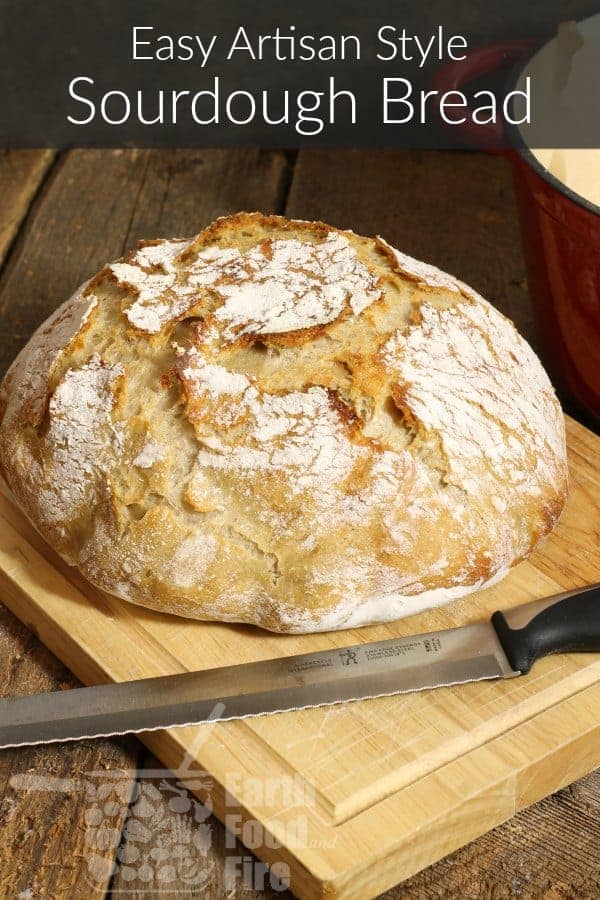 an artisan style sourdough loaf on a wooden cutting board