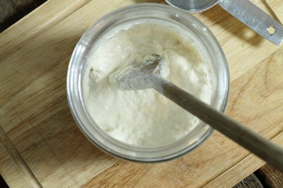 An overhead view of from scratch sour dough starter in a glass jar