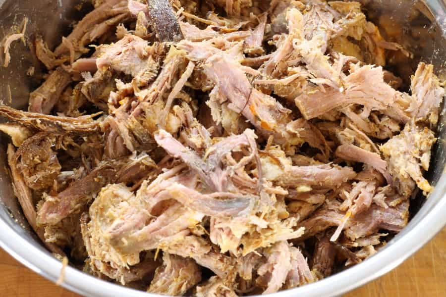 Pork shoulder shredded in a steel bowl