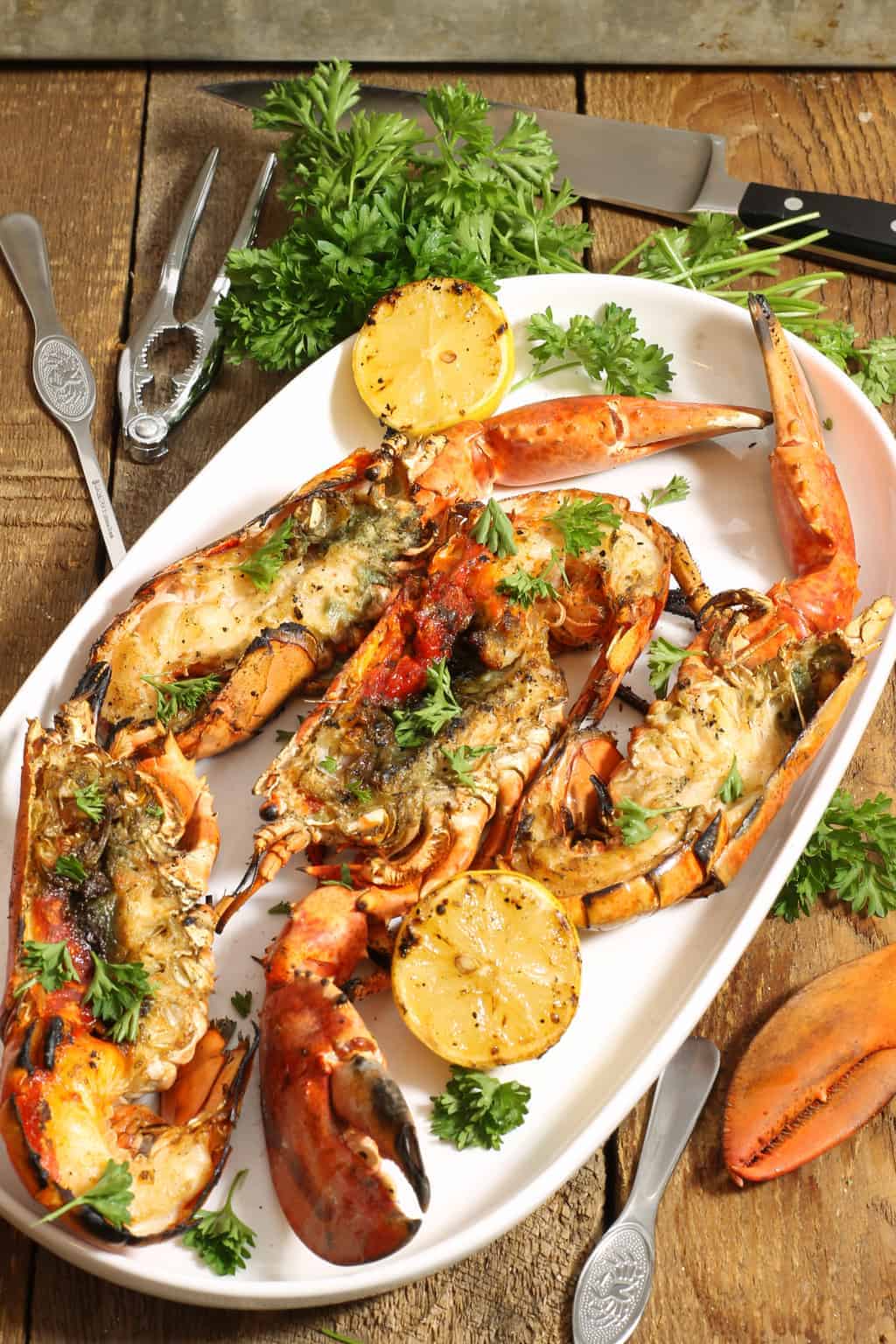 a large platter of whole grilled lobsters. The perfect gourmet BBQ meal or entree served at New Years