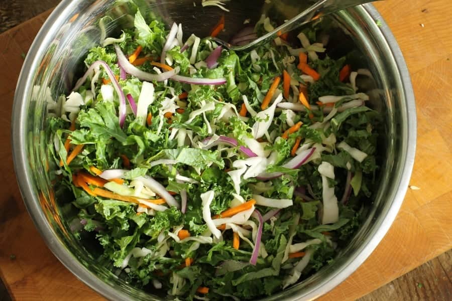 kale slaw mixed in a steel bowl without dressing