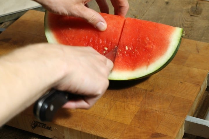 cutting a watermelon into slices