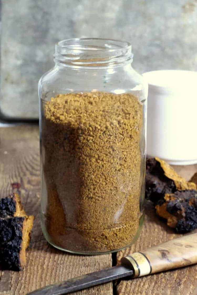 a glass jat filled with coarsly ground chaga mushroom