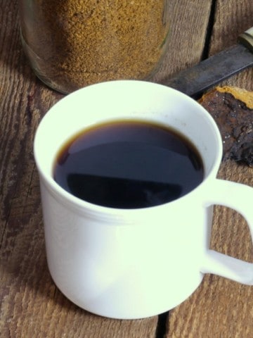 chaga mushroom tea in a white cup on a wooden tabletop