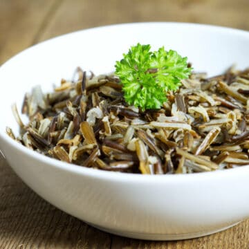 a white bowl filled with cooked wild rice