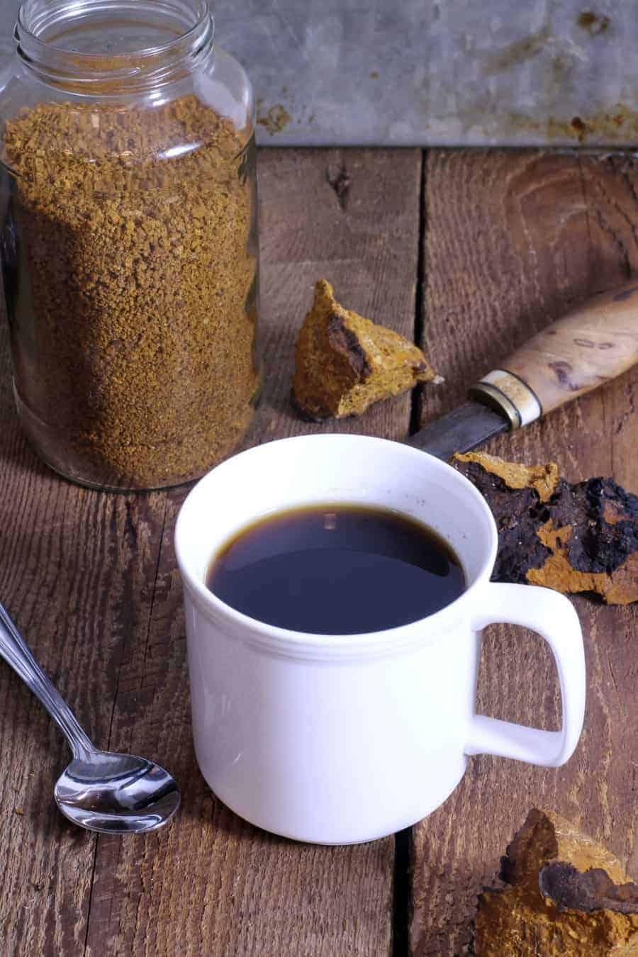 a cup of freshly brewed chaga using ground dried chaga