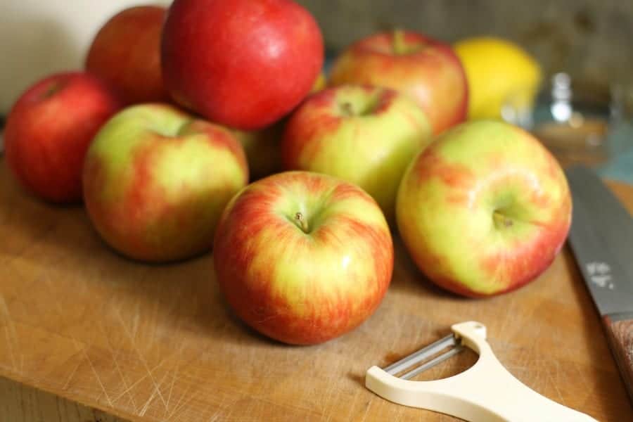 freshly picked honeycrisp apples on a wooden cutting board