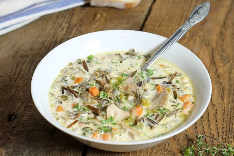 top down view of leftover turkey wild rice soup in a white bowl