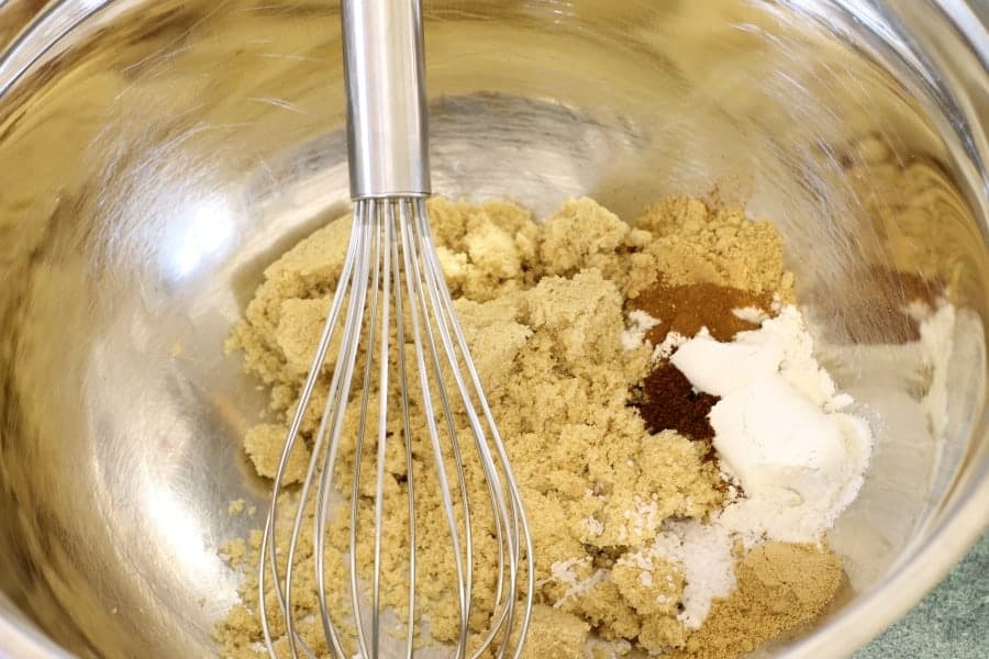 the dry ingredients needed for pumpkin pie in a stainless steel bowl