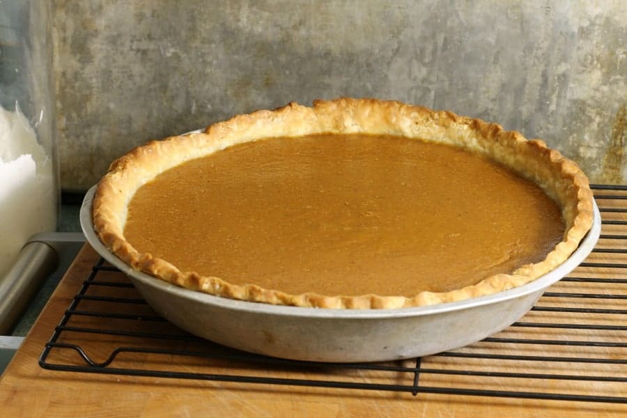 freshly baked pumpkin pie on a wire rack,