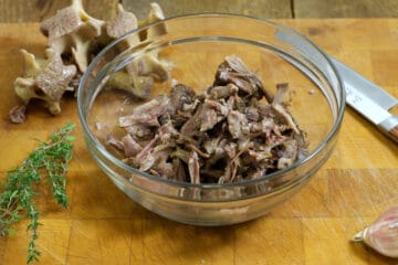 oxtail meat picked of the bones on a glass bowl