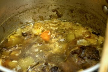 Oxtail broth in a pot after it has simmered