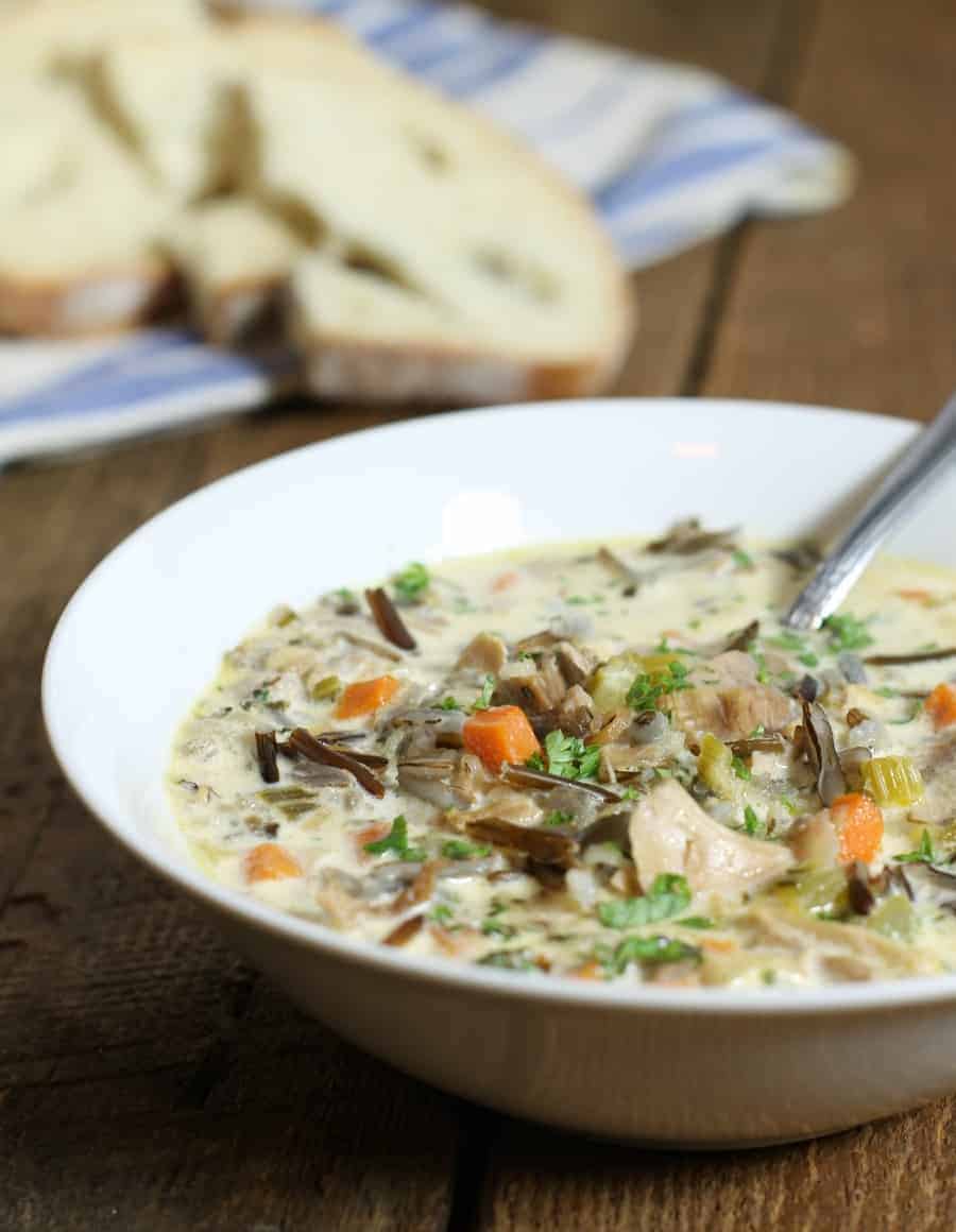 a close up of a bowl filled with leftover turkey and wild rice soup