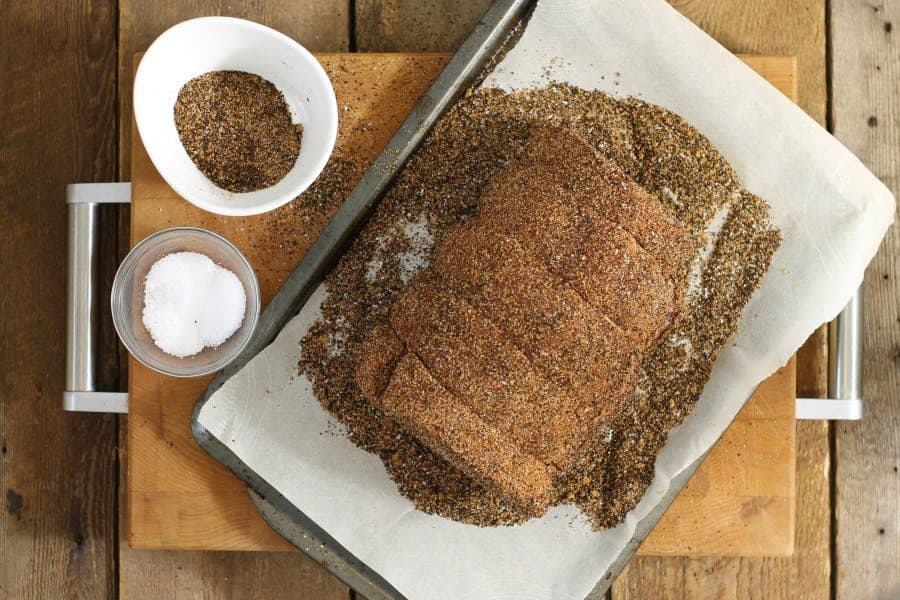 an uncooked sirloin tip roast heavily coated with a coffee rub spice mixture to marinate overnight