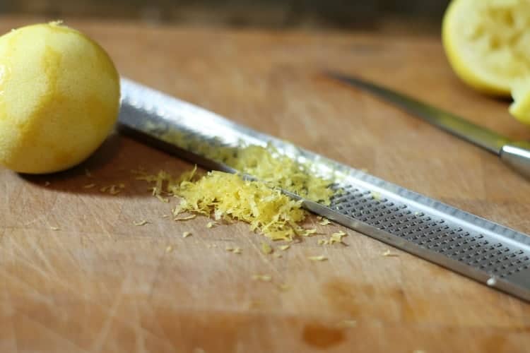 fresh lemon zest on a wooden cutting board