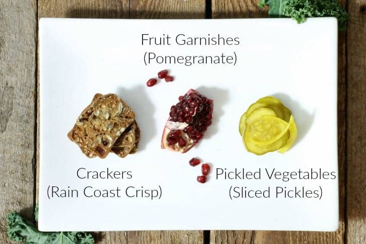 a selection of various garnishes used on a charcuterie platter displayed on a white plate and labeled