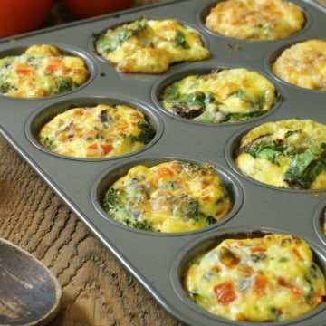 Three different kinds of breakfast egg muffins in a twelve cup muffin tin