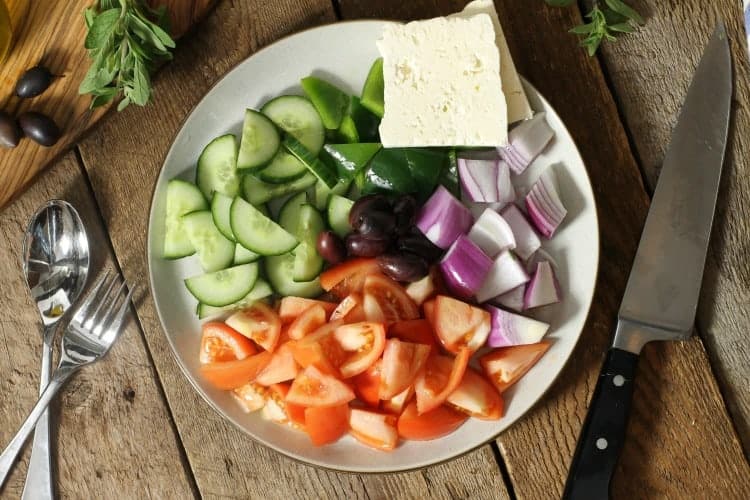 traditional greek salad ingredients served on a platter